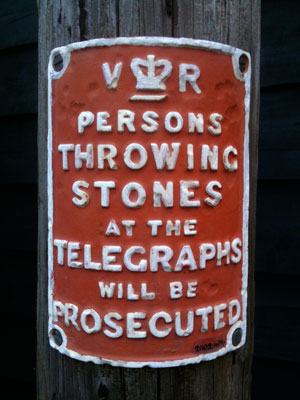 old notice headed 'V R' and reads - persons throwing stones at the telegraphs will be prosecuted